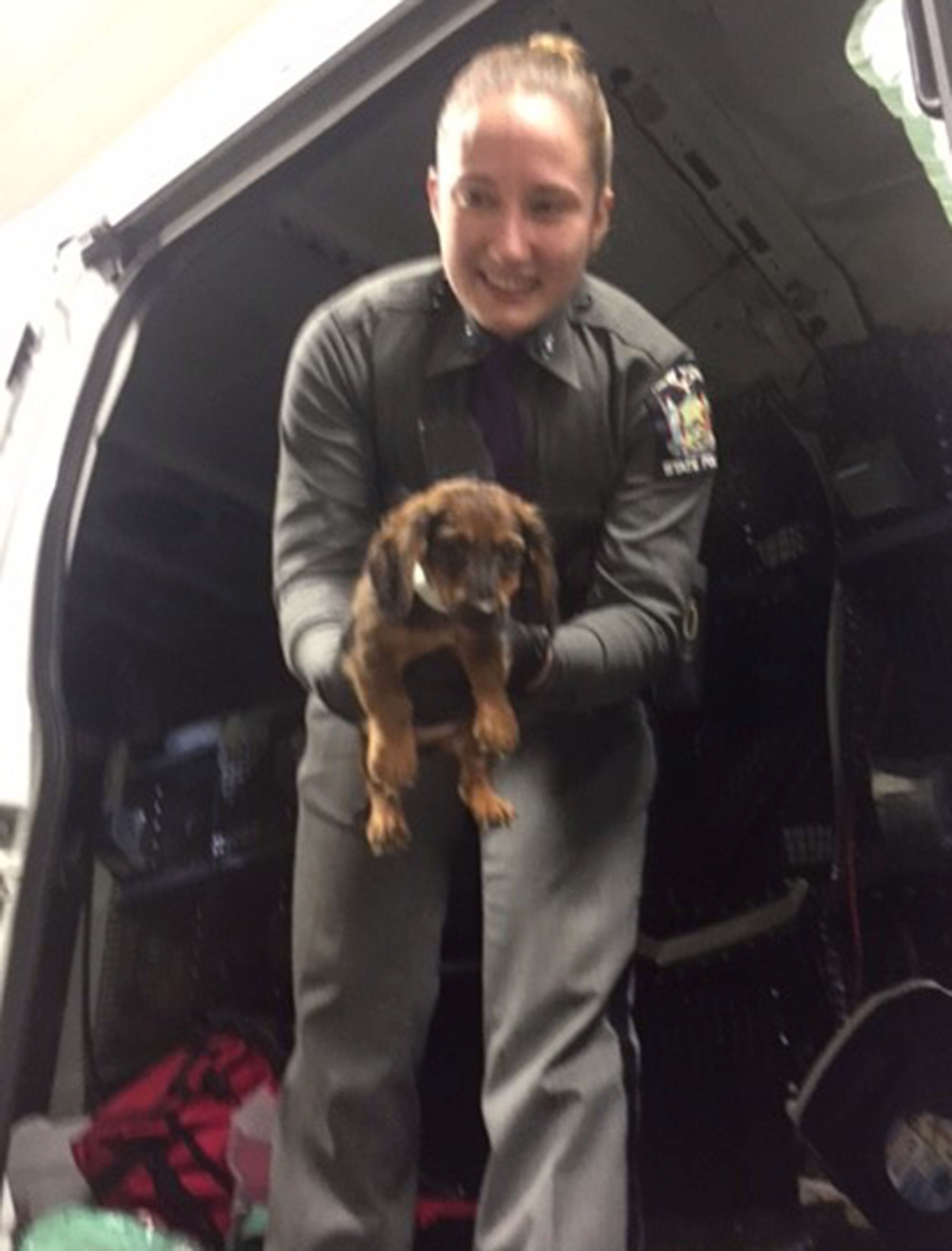 New York State Troopers with rescued puppies