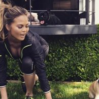 Chrissy Teigens Stretching with her pup
