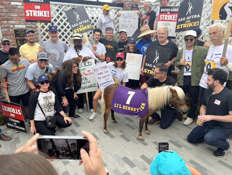 Parks and Rec cast with Lil Sebastian mini horse at the actors strike