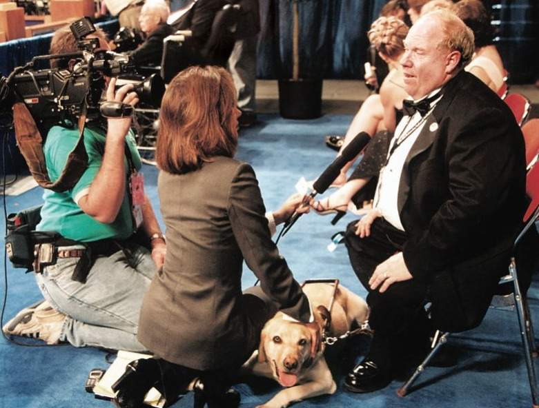 Guide dog Roselle and owner Michael Hingson in an interview
