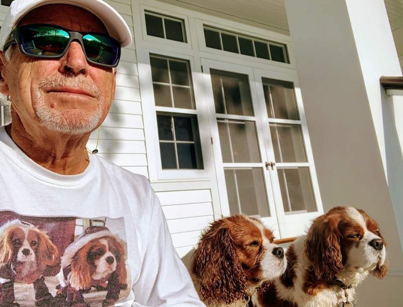 Jimmy Buffett wearing a t-shirt of his dogs