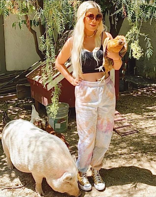 Tori Spelling with her pet chicken and pig