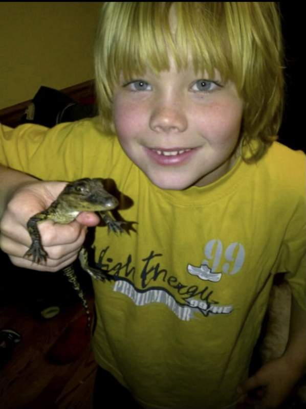 Carson Steele with baby Crocky J the alligator who was a Christmas gift