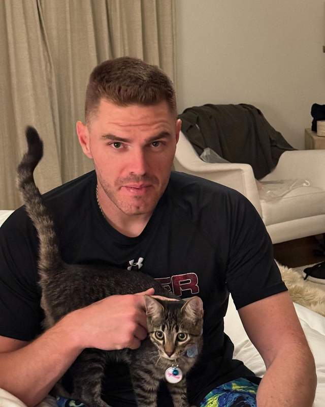 Freddie Freeman holding his adopted cat named Champ