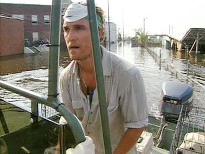 Matthew McConaughey driving a boat in New Orleans to rescue dogs